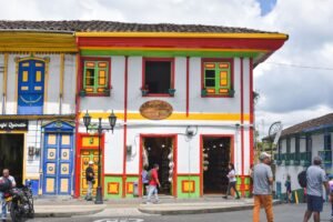 Vibrant colonial architecture on a bustling street in Salento, Colombia.