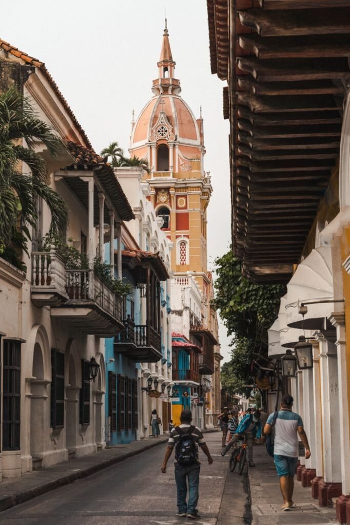 Scenic street scene in Cartagena featuring the iconic cathedral tower., Turismo en Colombia
