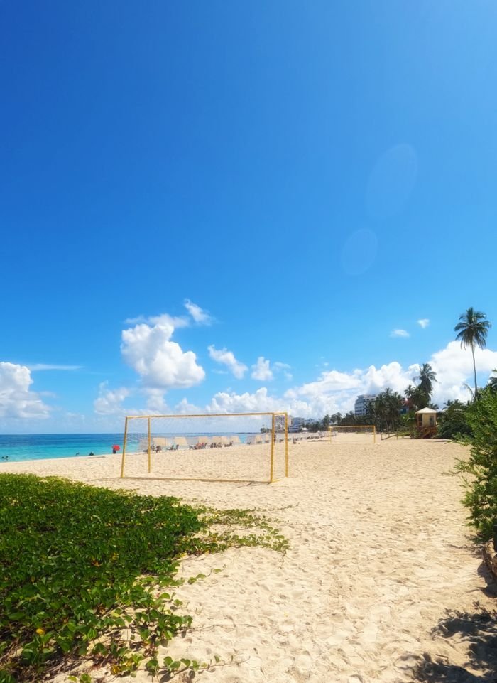 Bright sunny day on San Andrés beach with a football goal and blue sky., San Andrés