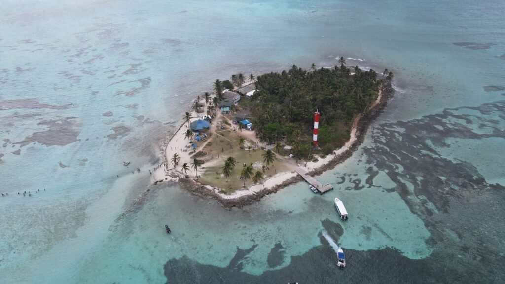 Aerial view of a small tropical island with a lighthouse in San Andrés, Colombia., San Andrés