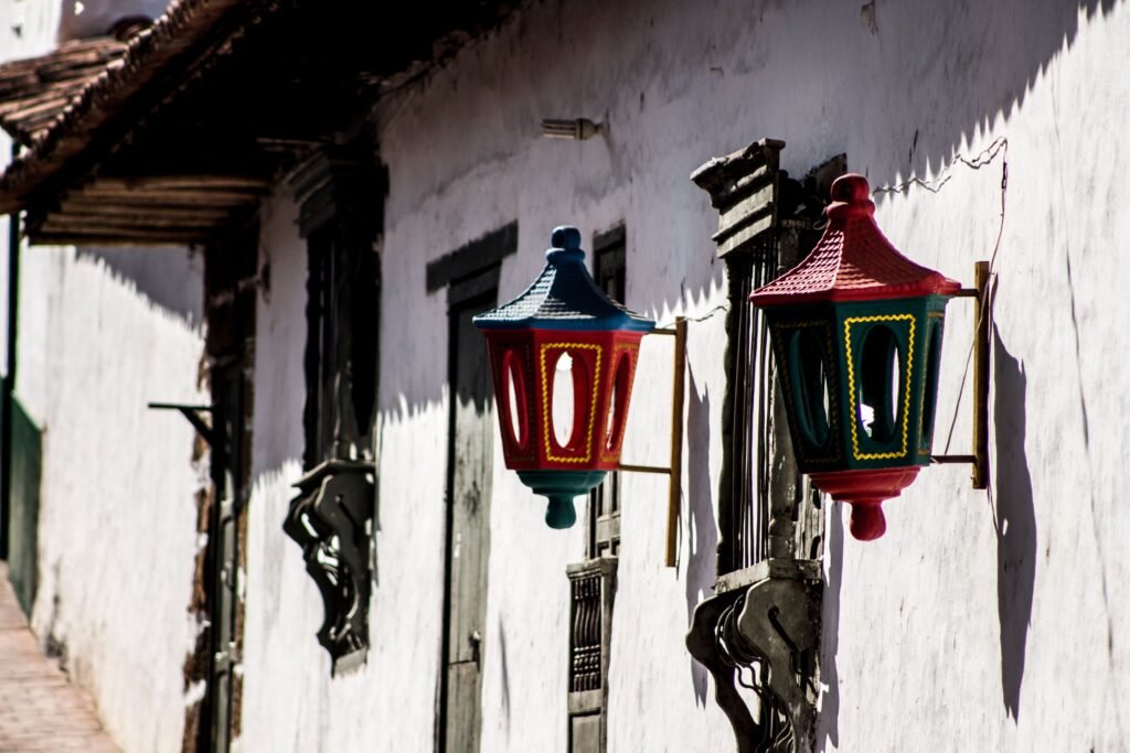 Brightly colored street lamps adorn a traditional building in Barichara, Colombia. Barichara